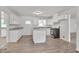 Remodeled kitchen with white cabinets, granite countertops and island at 2171 Bud Lipscomb Rd, Willow Springs, NC 27592