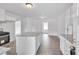 Bright kitchen with white cabinets, granite island, and wood flooring at 2171 Bud Lipscomb Rd, Willow Springs, NC 27592