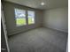 Bright bedroom with carpet flooring and two large windows at 139 Grace Ridge Ct, Benson, NC 27504