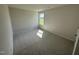 Well-lit bedroom featuring carpet flooring and a window at 139 Grace Ridge Ct, Benson, NC 27504
