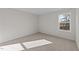 Sunny bedroom featuring a window and carpet at 36 Railcar Way, Clayton, NC 27520