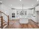 Modern kitchen with white cabinets, large island, and stainless steel appliances at 4705 Cypress Tree Ln, Raleigh, NC 27612