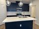 Modern kitchen island with white quartz countertop and dark blue cabinetry at 607 Hyperion Aly, Wake Forest, NC 27587