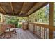 Wooden back porch with rocking chair and view of backyard at 2063 Knight St, Creedmoor, NC 27522