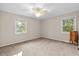 Bright bedroom with neutral carpeting and two windows at 2063 Knight St, Creedmoor, NC 27522