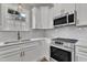 Modern kitchen with stainless steel appliances and white cabinets at 1425 S Elm Ave, Dunn, NC 28334