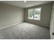 Spacious bedroom featuring a large window and neutral decor at 54 Bonsai Way, Four Oaks, NC 27524