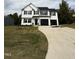 Two-story home with black accents and a long driveway at 54 Bonsai Way, Four Oaks, NC 27524