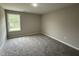 Well-lit bedroom with carpeted floor and a window offering natural light at 54 Bonsai Way, Four Oaks, NC 27524