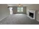 Living room features a fireplace and large windows at 54 Bonsai Way, Four Oaks, NC 27524