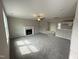Open living room with fireplace and view into kitchen at 54 Bonsai Way, Four Oaks, NC 27524