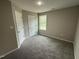 Bright bedroom with carpeted floor and neutral walls at 54 Bonsai Way, Four Oaks, NC 27524