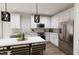 Modern kitchen with stainless steel appliances and an island with seating at 2413 Adrift Rd, Fuquay Varina, NC 27526