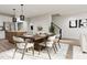 Bright dining room with wood table and chairs, adjacent to kitchen and living room at 2413 Adrift Rd, Fuquay Varina, NC 27526