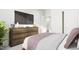 Comfortable bedroom with a dresser and large TV at 2413 Adrift Rd, Fuquay Varina, NC 27526