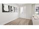 Spacious entryway with hardwood floors, white walls, and modern light fixture at 2413 Adrift Rd, Fuquay Varina, NC 27526