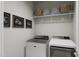 Convenient laundry room with washer, dryer, and shelving at 2413 Adrift Rd, Fuquay Varina, NC 27526