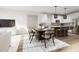 Modern kitchen with island and breakfast bar, open to dining and living areas at 2413 Adrift Rd, Fuquay Varina, NC 27526