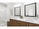 Modern bathroom with double vanity, large mirror and walk-in shower at 2413 Adrift Rd, Fuquay Varina, NC 27526