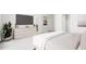 Bright bedroom with dresser and large TV, offering ample space and natural light at 2413 Adrift Rd, Fuquay Varina, NC 27526