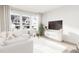 Modern living room with large windows, comfortable seating, and a flat-screen TV at 2413 Adrift Rd, Fuquay Varina, NC 27526