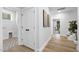 Light hallway with hardwood floors and access to laundry and stairs at 3024 White Rail Dr, Fuquay Varina, NC 27526