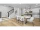 Modern kitchen with white cabinets, an island, and a dining table at 2411 Adrift Rd, Fuquay Varina, NC 27526