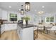 Open concept kitchen and dining area with an island and white cabinets at 2411 Adrift Rd, Fuquay Varina, NC 27526