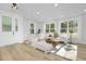 Bright and airy living room with hardwood floors and large windows at 2411 Adrift Rd, Fuquay Varina, NC 27526