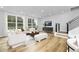 Spacious living room featuring hardwood floors, a modern aesthetic, and ample natural light at 2411 Adrift Rd, Fuquay Varina, NC 27526