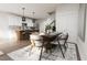 Modern dining room with a wooden table and gray chairs, near the kitchen at 2415 Adrift Rd, Fuquay Varina, NC 27526