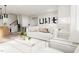 Spacious living room showcasing a comfortable white couch and accent chairs at 2415 Adrift Rd, Fuquay Varina, NC 27526