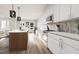 Modern kitchen with white cabinets and stainless steel appliances at 2415 Adrift Rd, Fuquay Varina, NC 27526
