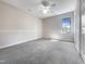 Bedroom with ceiling fan, neutral walls and carpet, and a window at 27 Pine Croft Rd, Angier, NC 27501