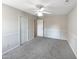 Bedroom with ceiling fan, neutral walls and carpet, and double door closet at 27 Pine Croft Rd, Angier, NC 27501