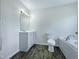 Modern bathroom with gray vanity, bathtub, and wood-look floors at 27 Pine Croft Rd, Angier, NC 27501