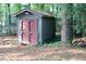 Yard storage shed with double doors, nestled among trees at 3404 Gemini Dr, Raleigh, NC 27604