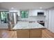 Modern kitchen with island, stainless steel appliances, and granite countertops at 3404 Gemini Dr, Raleigh, NC 27604