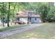 Two-story house with wood siding, deck, and driveway at 3404 Gemini Dr, Raleigh, NC 27604