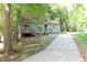 Two-story house with wood siding, deck, and driveway at 3404 Gemini Dr, Raleigh, NC 27604