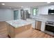 Kitchen island with granite countertop and hardwood floors at 3404 Gemini Dr, Raleigh, NC 27604
