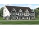 Three-unit townhome building with modern farmhouse exterior, featuring gray and white siding at 3024 White Rail Dr, Fuquay Varina, NC 27526