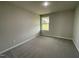 Bright bedroom with carpet flooring and a large window at 53 Grace Ridge Ct, Benson, NC 27504
