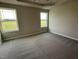 Main bedroom with carpet, two windows, and a ceiling fan at 53 Grace Ridge Ct, Benson, NC 27504