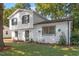 Two story house with white siding, black windows, and landscaping at 3204 Idlewood Village Dr, Raleigh, NC 27610