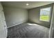 Bright bedroom with grey carpet and large window at 95 Grace Ridge Ct, Benson, NC 27504