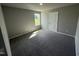 Spacious bedroom with grey carpet and a window at 95 Grace Ridge Ct, Benson, NC 27504