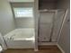Bathroom featuring a soaking tub and a separate shower stall at 95 Grace Ridge Ct, Benson, NC 27504