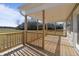 Wooden porch with railing overlooking grass fields. Perfect for outdoor relaxation at 7814 Nc 27, Coats, NC 27521