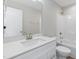 Clean, modern bathroom with white vanity, shower, and toilet at 7814 Nc 27, Coats, NC 27521